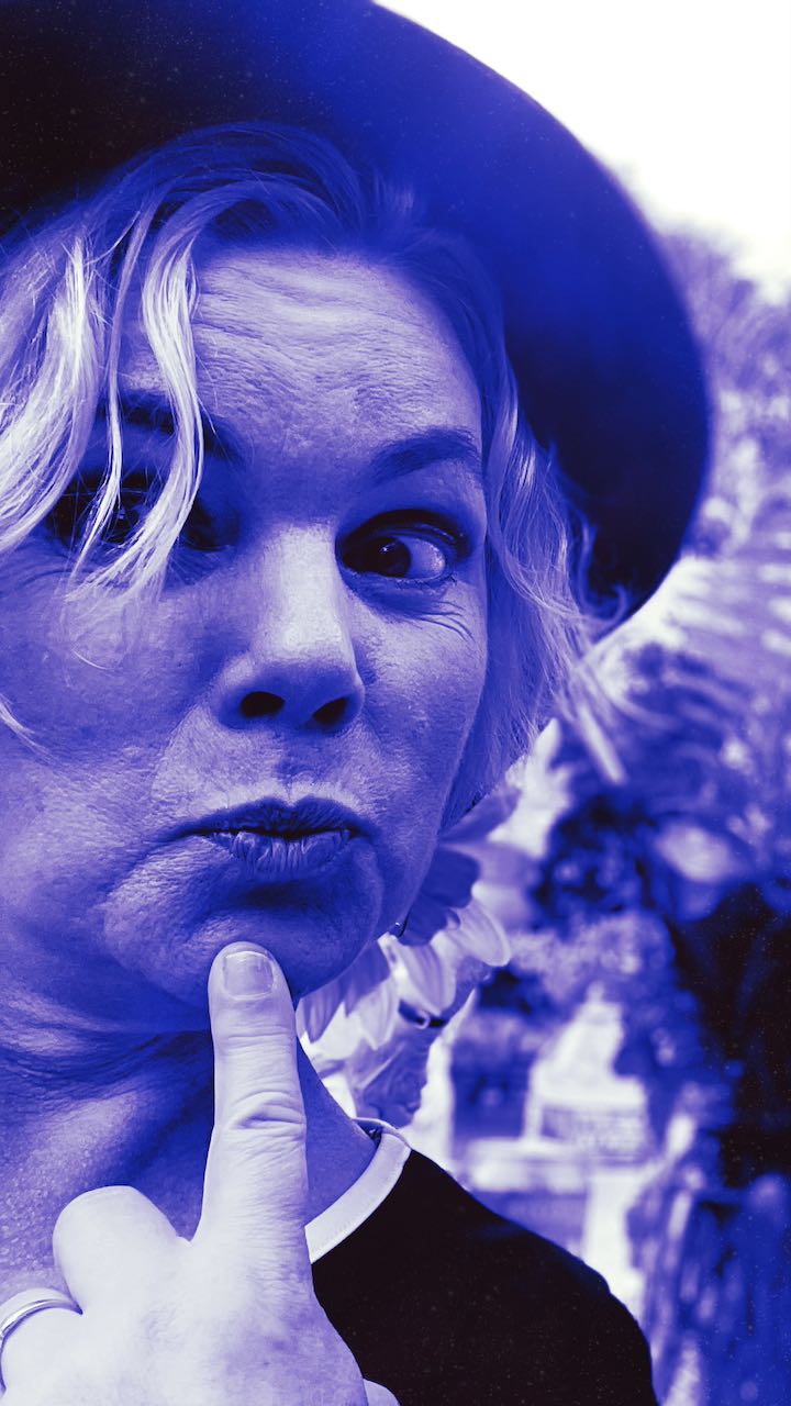 author Sara Kerr demonstrating her playful side in ablue-toned photo